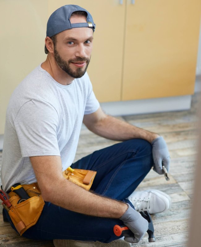 full-length-shot-of-young-repairman-looking-at-camera-holding-plumbing-tools-in-his-hands.jpg